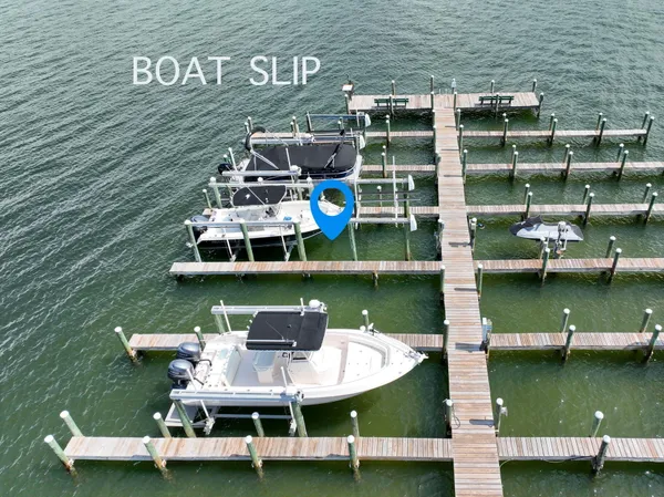 a view of a lake with boats in front of house