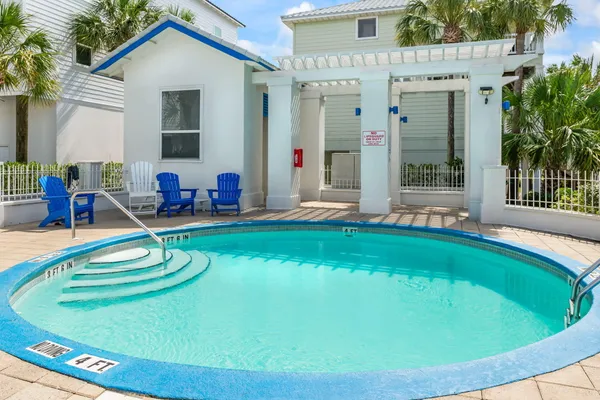 a view of a house with backyard swimming pool and sitting area