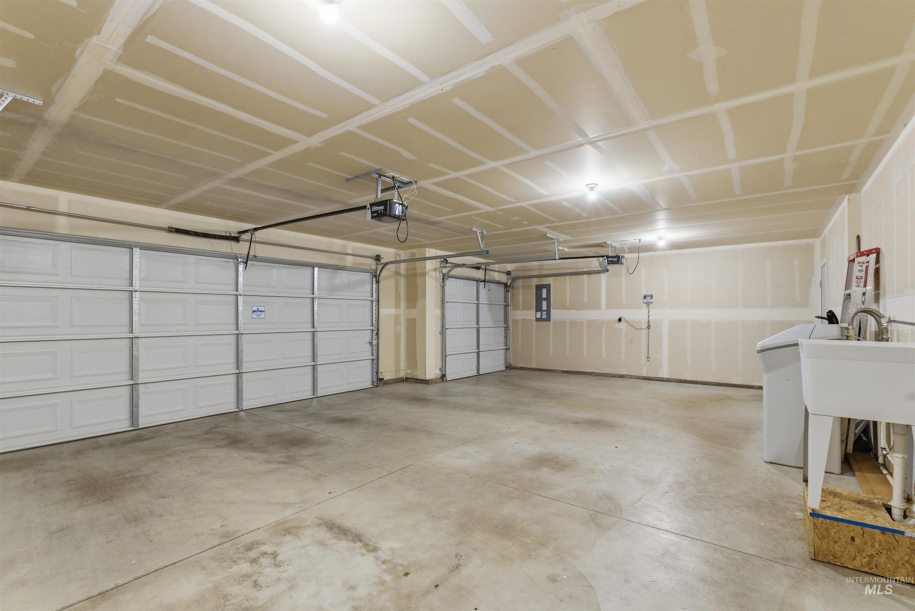 1555 Condor Drive Middleton, ID 83644 - Photo 42 of 50 Spacious multi-car garage featuring two overhead doors, automatic openers, and concrete flooring