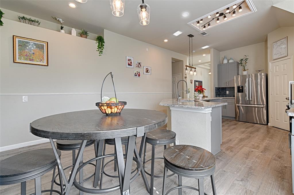2704 Spring Drive McKinney, TX 75072 - Photo 11 of 35 a kitchen with a table and chairs in it