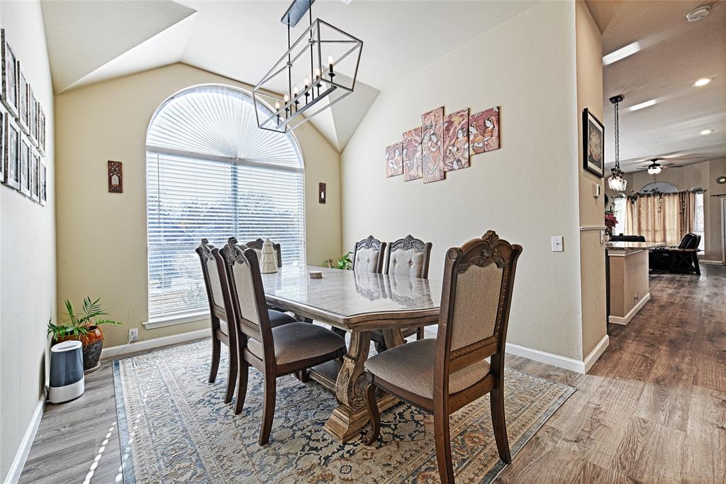 2704 Spring Drive McKinney, TX 75072 - Photo 12 of 35 a view of a dining room with furniture wooden floor and a chandelier