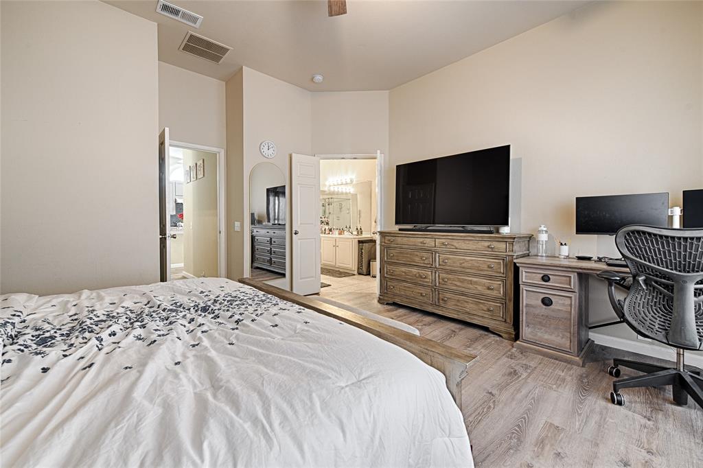 2704 Spring Drive McKinney, TX 75072 - Photo 14 of 35 a bedroom with a bed and a flat screen tv