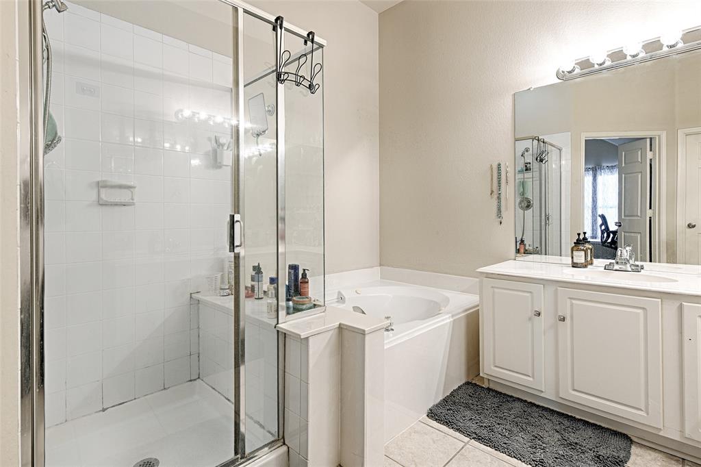 2704 Spring Drive McKinney, TX 75072 - Photo 17 of 35 a bathroom with a double vanity sink mirror and shower