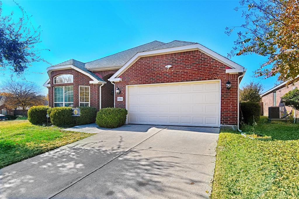2704 Spring Drive McKinney, TX 75072 - Photo 30 of 35 a front view of a house with a yard and garage