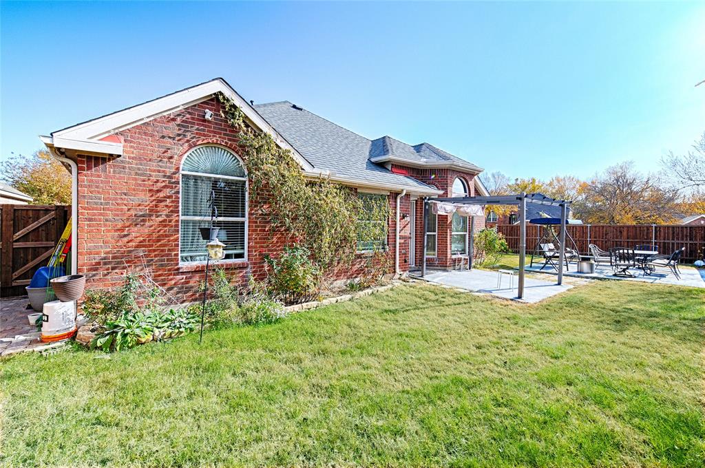 2704 Spring Drive McKinney, TX 75072 - Photo 31 of 35 a front view of a house with garden