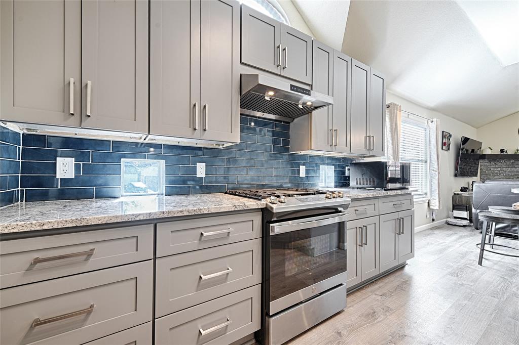 2704 Spring Drive McKinney, TX 75072 - Photo 9 of 35 a kitchen with granite countertop white cabinets and stainless steel appliances