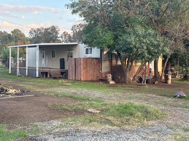 a view of outdoor space with green field and trees all around