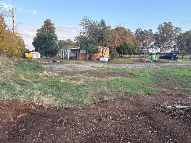 a view of green field with sitting area
