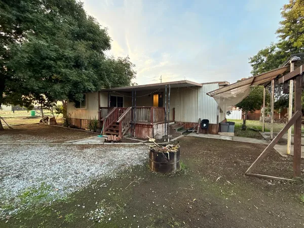 a view of a house with backyard and sitting area