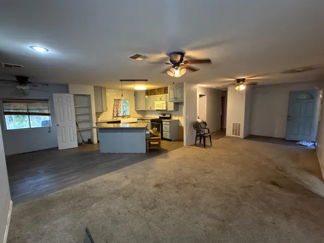 a view of a livingroom with a kitchen