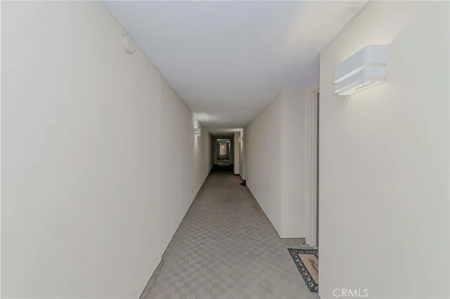 a view of a hallway with wooden staircase