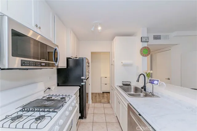 a kitchen with a sink stove and refrigerator