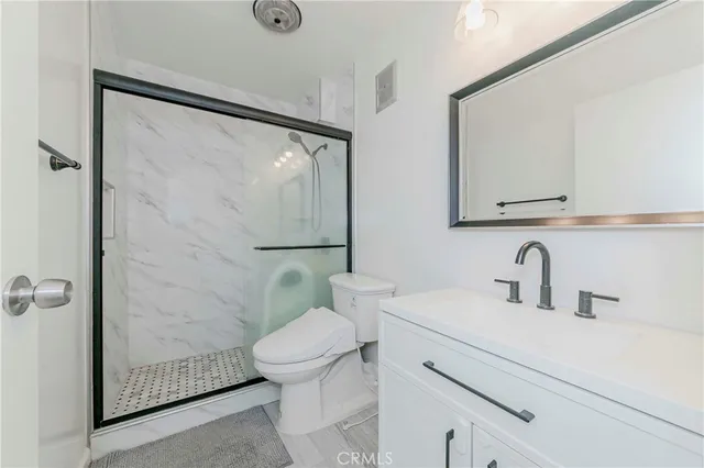 a bathroom with a sink mirror vanity and toilet