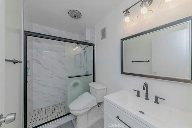 a bathroom with a sink toilet and shower