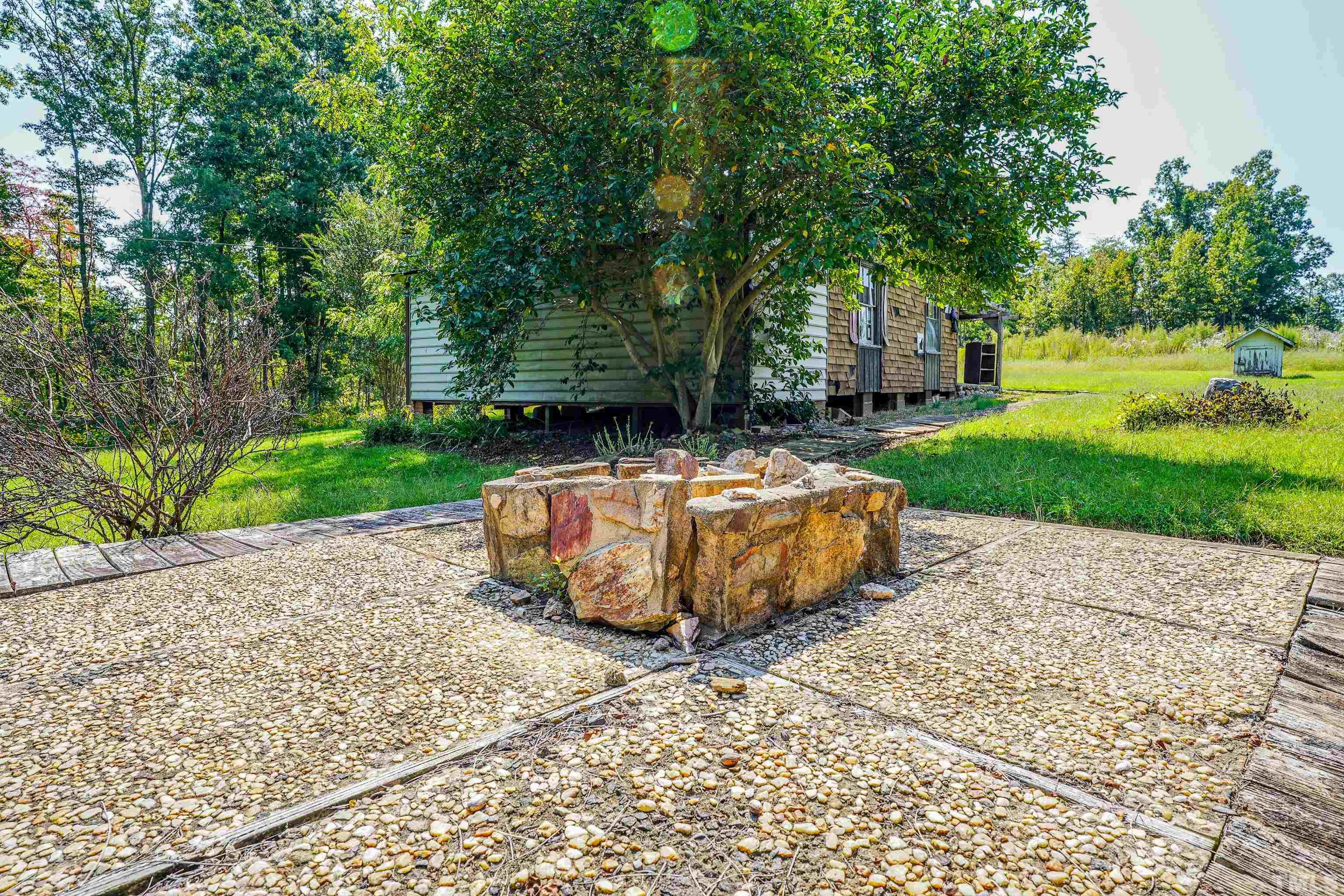 3640 Old Allensville Road Roxboro, NC 27574 - Photo 54 of 94 a view of a backyard with large trees