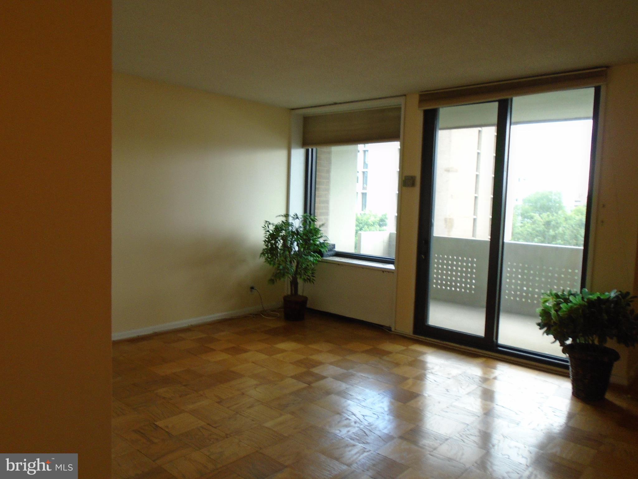 1250 4th Street Southwest, Unit W403 Washington, DC 20024 - Photo 15 of 41 a view of an empty room with wooden floor and a window
