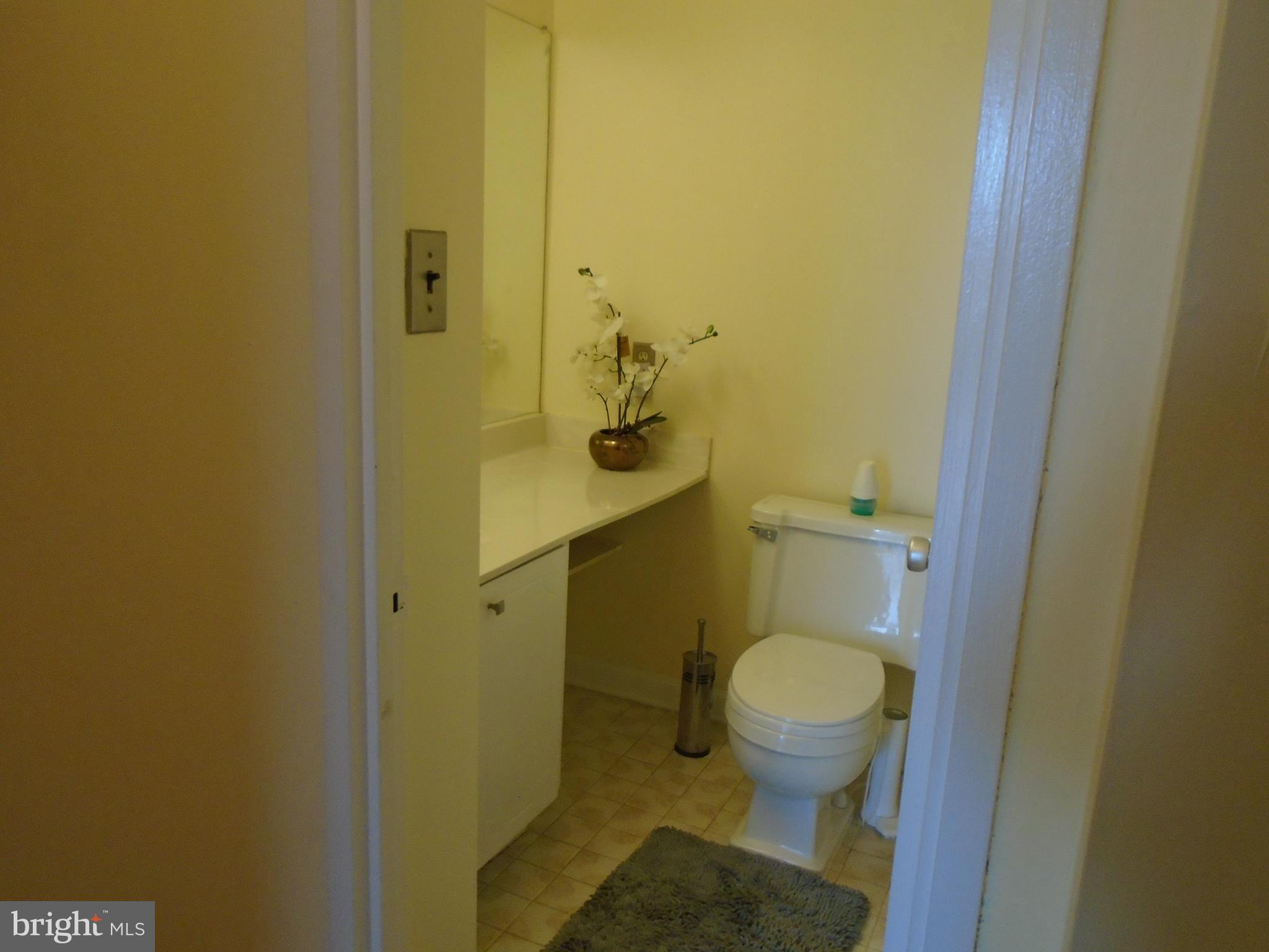 1250 4th Street Southwest, Unit W403 Washington, DC 20024 - Photo 23 of 41 a bathroom with a granite countertop toilet and a sink