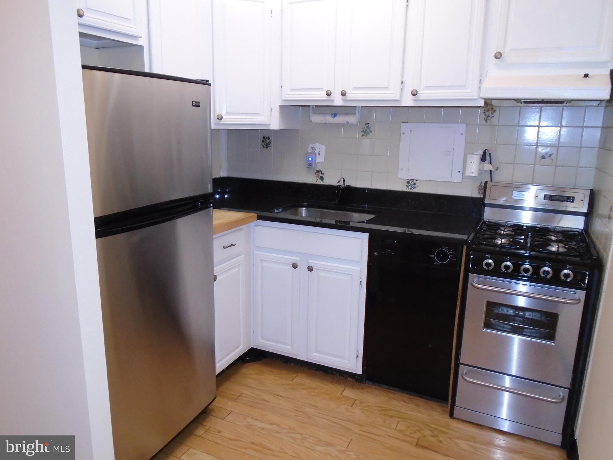 1250 4th Street Southwest, Unit W403 Washington, DC 20024 - Photo 6 of 41 a kitchen with stainless steel appliances granite countertop a refrigerator and a stove