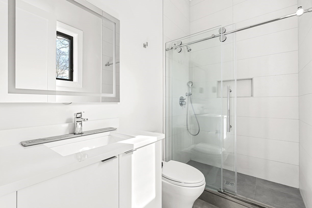 180 Allen Avenue Newton, MA 02468 - Photo 19 of 36 a bathroom with a sink a toilet and shower