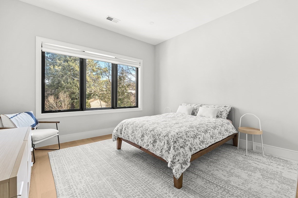 180 Allen Avenue Newton, MA 02468 - Photo 20 of 36 a bedroom with a bed and a large window