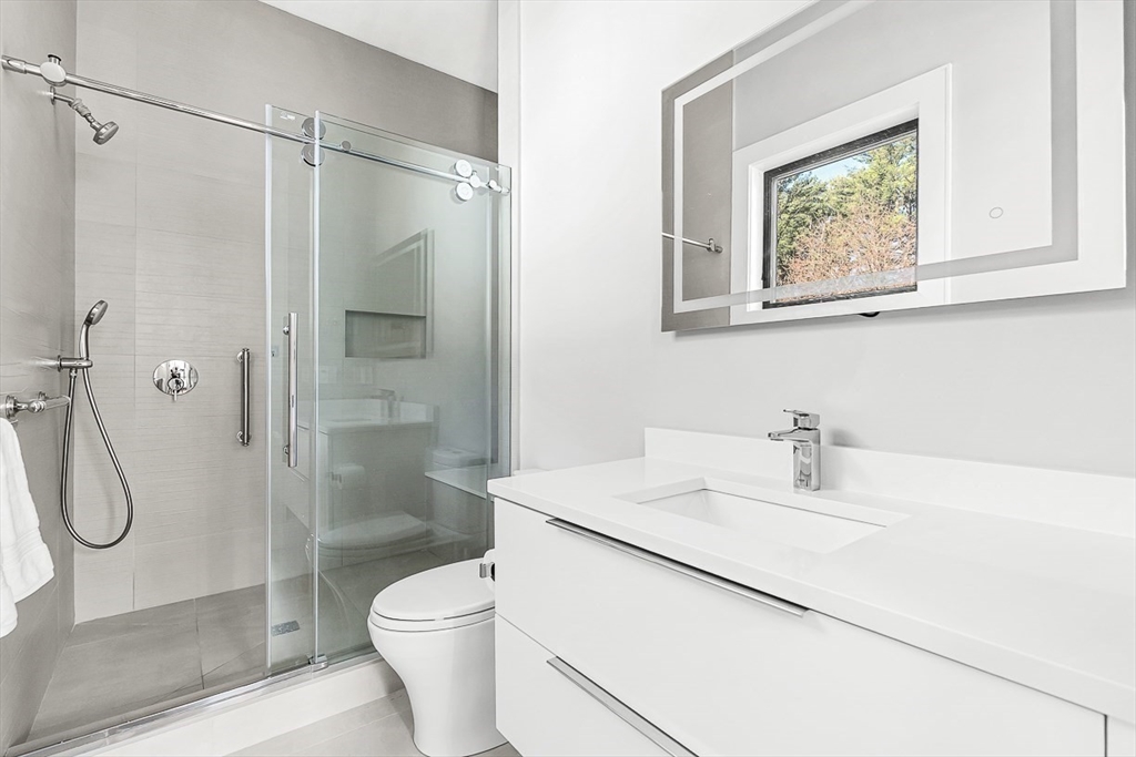 180 Allen Avenue Newton, MA 02468 - Photo 23 of 36 a bathroom with a granite countertop sink a toilet and shower