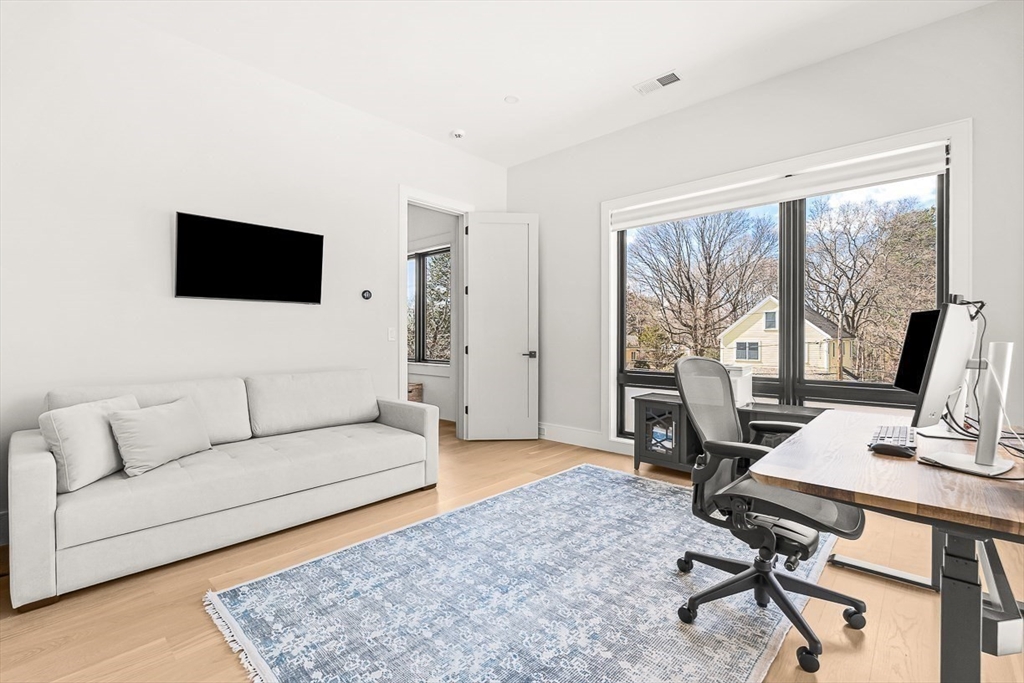 180 Allen Avenue Newton, MA 02468 - Photo 24 of 36 a living room with furniture and a flat screen tv