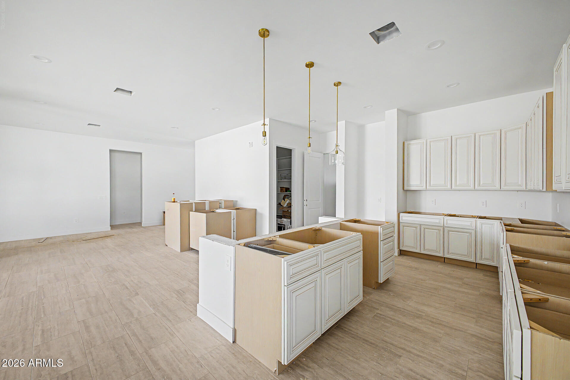 18815 West Arlington Road Buckeye, AZ 85326 - Photo 17 of 56 a kitchen that has a lot of white cabinets and stainless steel appliances
