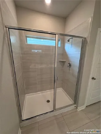 a bathroom with a glass shower door
