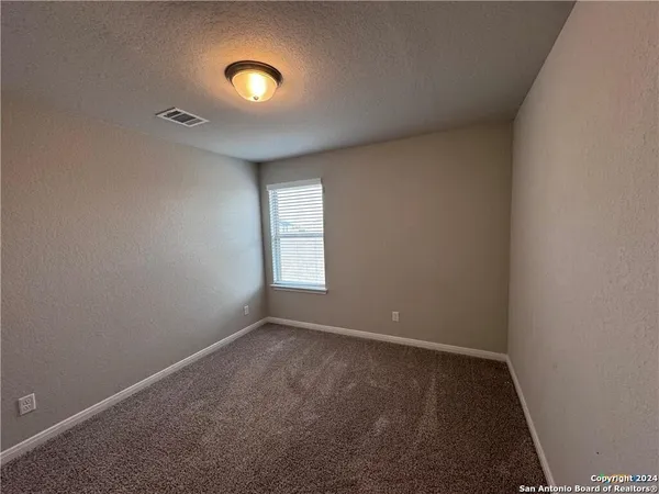 a view of a room with window and stairs