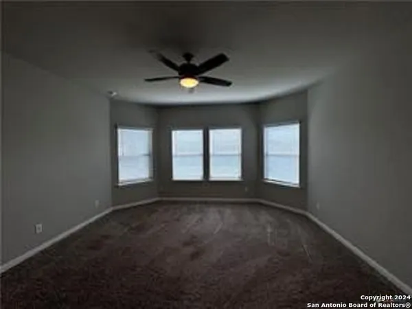 an empty room with a empty space and windows