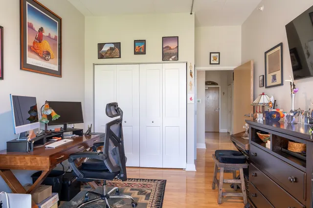 a view of a workspace with furniture and a flat screen tv