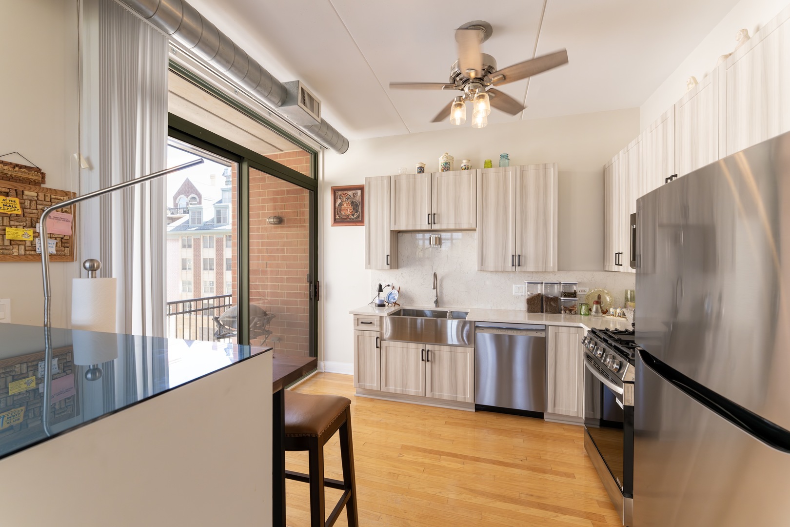 1 South Highland Avenue, Unit 400 Arlington Heights, IL 60005 - Photo 7 of 24 a kitchen with stainless steel appliances a stove a refrigerator and a kitchen island