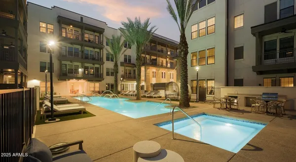 a view of a swimming pool with outdoor seating