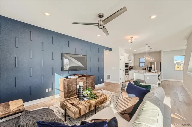 a living room with furniture and a wooden floor