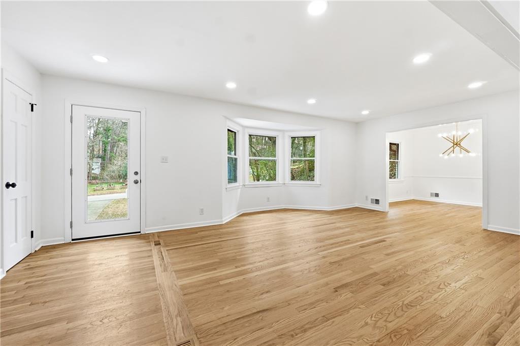 2520 Overlook Way Northeast Atlanta, GA 30345 - Photo 4 of 31 an empty room with wooden floor and windows