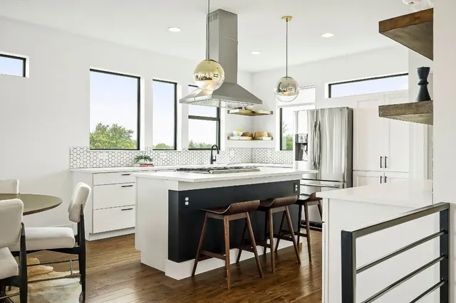 a kitchen with white cabinets and appliances