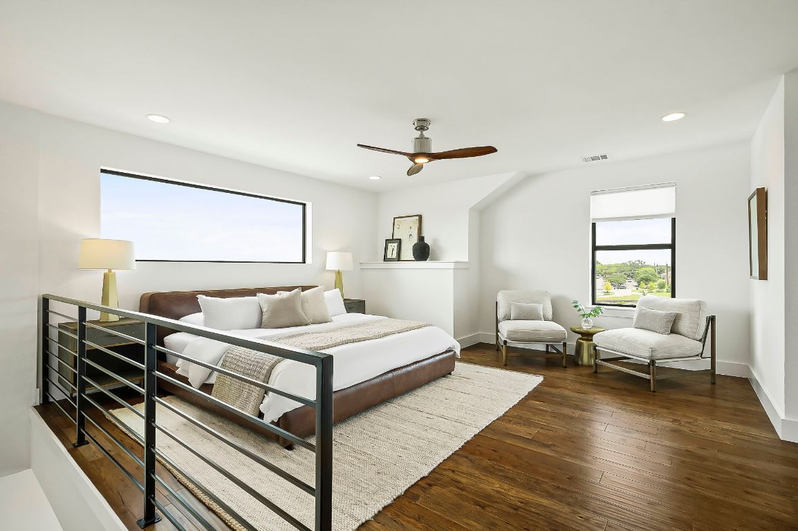 1104 Marcy Street, Unit B Austin, TX 78745 - Photo 19 of 34 a bedroom with a bed and wooden floor