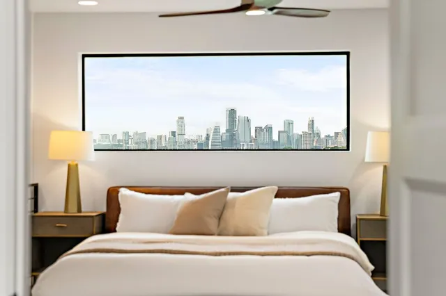 a bedroom with a bed and wooden floor