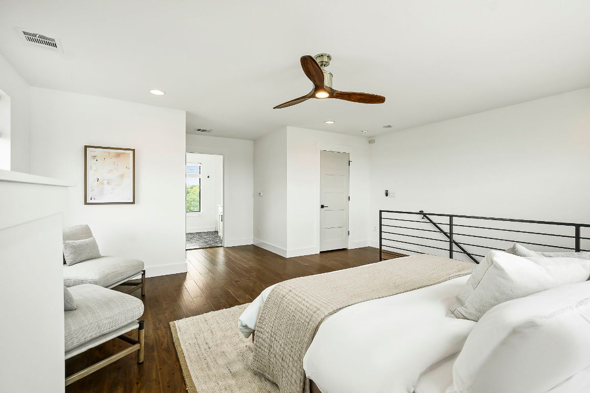 1104 Marcy Street, Unit B Austin, TX 78745 - Photo 22 of 34 a bedroom with a bed and wooden floor