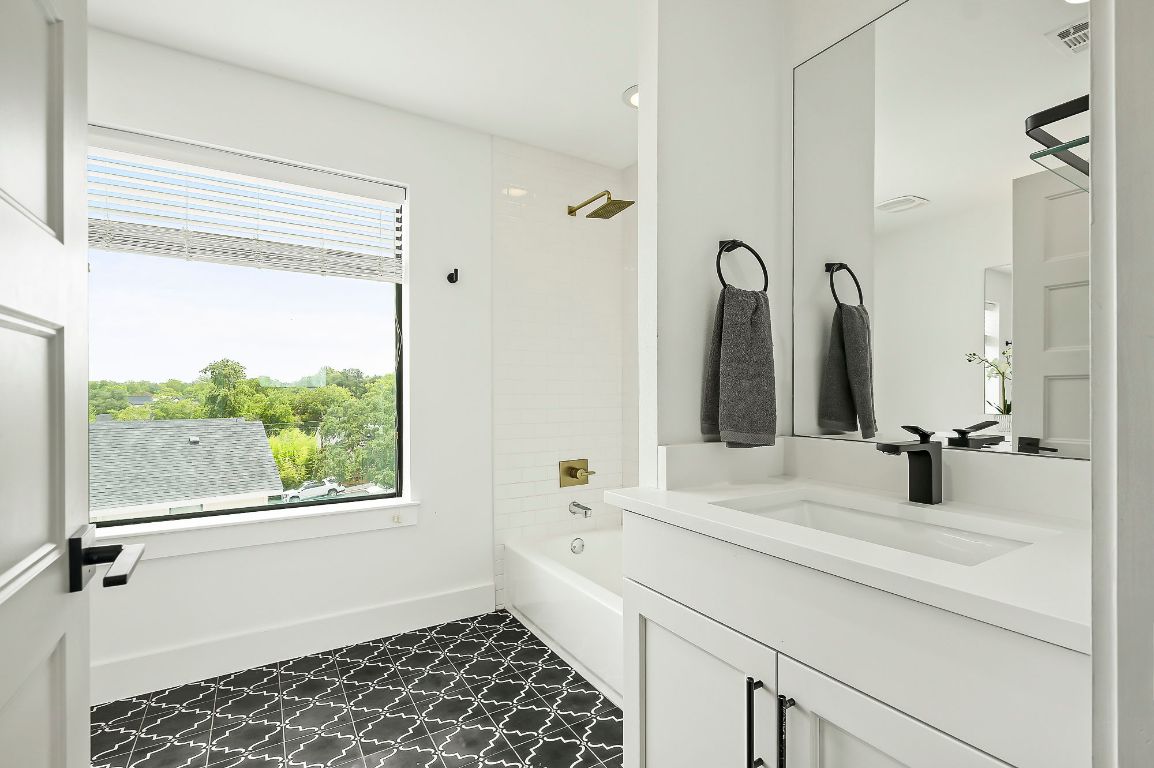1104 Marcy Street, Unit B Austin, TX 78745 - Photo 23 of 34 a bathroom with a double vanity sink and a mirror
