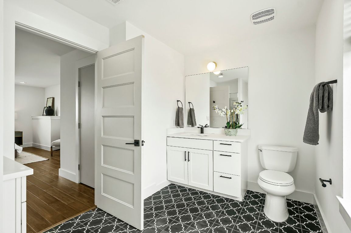 1104 Marcy Street, Unit B Austin, TX 78745 - Photo 24 of 34 a bathroom with a sink a toilet and shower