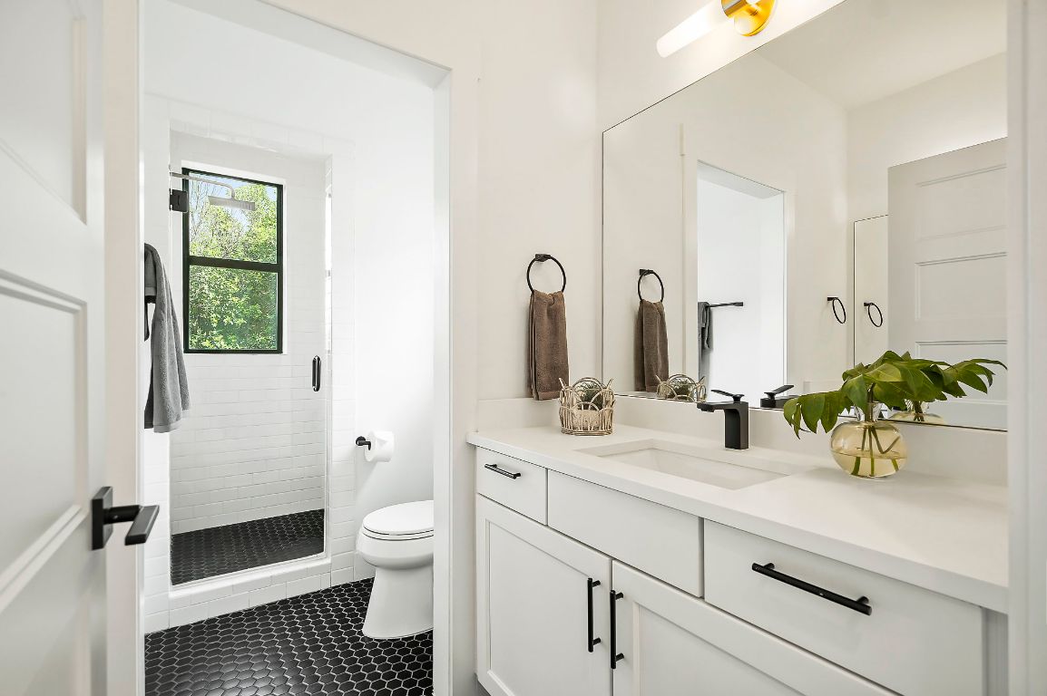 1104 Marcy Street, Unit B Austin, TX 78745 - Photo 9 of 34 a bathroom with a sink a toilet and shower