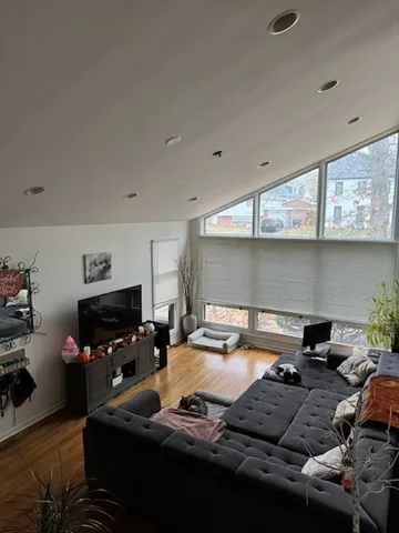 a kitchen with furniture a refrigerator and a stove