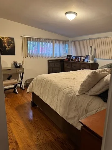a living room with a bed furniture and a large window