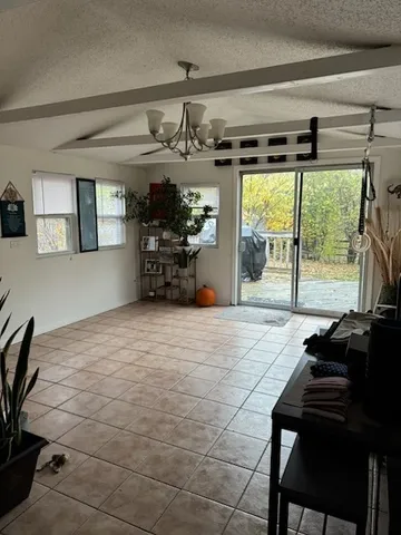 a bedroom with furniture and a large window