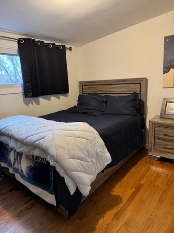a bedroom with a bed and a television