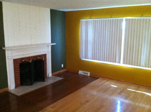 23 Woodcliff Road Montgomery, IL 60538 - Photo 4 of 16 a view of an empty room with a fireplace and a window