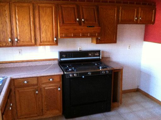 23 Woodcliff Road Montgomery, IL 60538 - Photo 7 of 16 a kitchen with wooden cabinets and a stove top oven