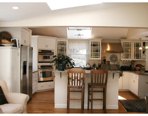 17 Round Hill Road Weston, MA 02493 - Photo 1 of 17 a kitchen with stainless steel appliances kitchen island granite countertop a refrigerator and cabinets