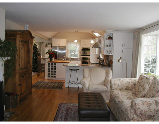17 Round Hill Road Weston, MA 02493 - Photo 14 of 17 a living room with furniture a rug and kitchen view